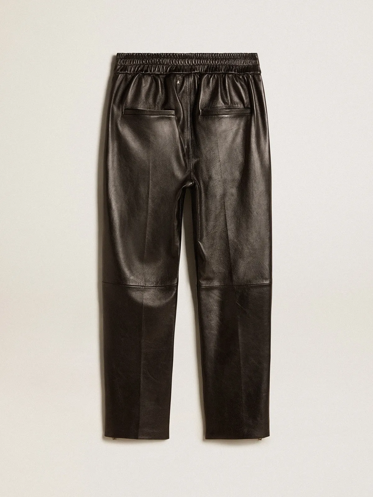 Black joggers in nappa leather with zip at the base