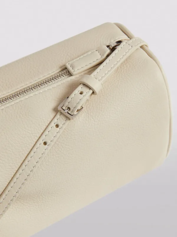 The Row 90's Leather Baguette Bag Ivory | Luxury and style at your fingertips